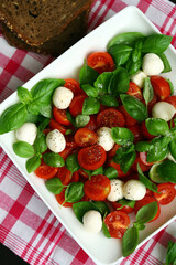 Wall Mural - Caprese salad with mozzarella balls and basil.