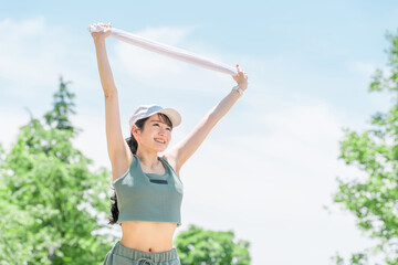 Wall Mural - 公園で運動・トレーニング・ウォーキング・ストレッチする女性(タオル・発汗・デトックス)
