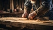 Carpenters hands shaping wood with a saw