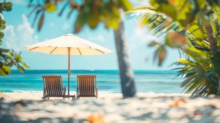 Two wooden sun loungers under a parasol on a serene tropical beach.