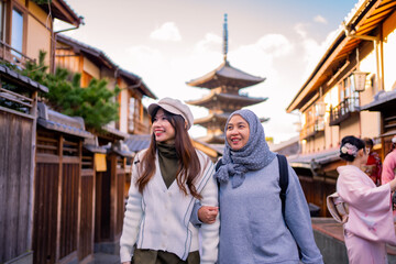 Travel, muslim travel,  woman girl tourist Two Asian friends but different religions walking at Yasaka Pagoda and Sannen Zaka Street in Kyoto Japan, Yasaka Pagoda is the famous landmark and travel.