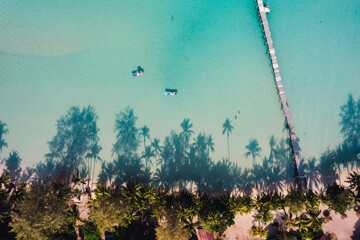 Beach with clear blue sea and palm tree shadows