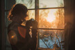 A thoughtful person holding a vintage camera, standing by a window during golden hour, capturing the intricate dance of light and shadow