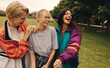 © Jacob Lund - Three female friends having a fun day out in the park, laughing and socializing