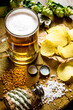 Beer rustic style . Beer and chips on wooden background.
