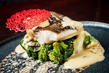 Wall Mural - white fish with broccoli and sauce