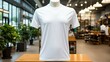 A white empty T-shirt on a mannequin in a fashion store.