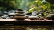 Zen stones and green leaves on wooden table, spa and wellness concept