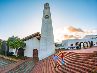 Sunset at Guatavita, Cundinamarca with a couple, locals, and a tower
