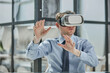 © Katsiaryna - businessman in virtual reality headset in the office