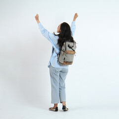 backview full leght shoot of happy asian Indonesian woman wearing casual attire and backpack on isolated background