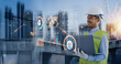 © SOMKID - Double exposure of engineering holding laptop with Technology construction interface icon graphic showing automation system, Construction technology and control future industrial concept.