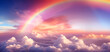 Sunrise with rainbow above clouds