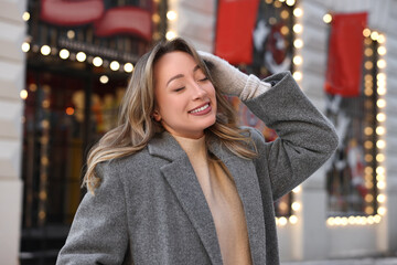 Sticker - Portrait of smiling woman on city street in winter