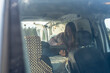 © Westend61 - Smiling woman with tablet PC in camper van seen through windshield