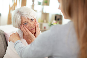 daughter supports her elderly mother in a difficult moment