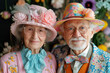 Beautiful senior old couple wearing fancy party clothes and hats on festive background