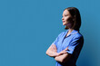 © Valerii Honcharuk - Portrait of young serious female nurse looking in profile on blue background