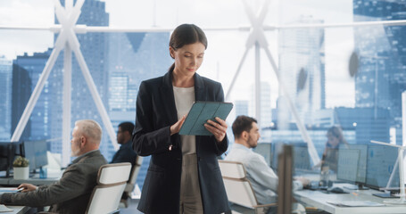 Fototapete - Successful Businesswoman Using Tablet Computer, Standing in Modern Diverse Office in Downtown, And Working on Financial, Business, and Marketing Projects. Portrait of Beautiful Caucasian Manager.
