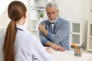 Sticker - Arthritis symptoms. Doctor consulting patient with shoulder pain in hospital