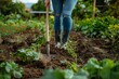 © Pinklife - A close look at the hands planting seedlings with a spade in the fertile ground of a blooming organic garden