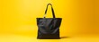 Black tote bag cotton mockup on yellow background.