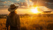 © Keitma - Woman looking at sunset over savannah during her safari holidays in Africa with copy space