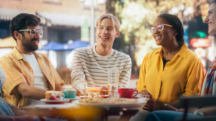 Wall Mural - African, Indian and Caucasian College Students Celebrating Summer Holidays on a Bar Terrace. Young Multiethnic University Friends Enjoying the Weekend, Talking and Having Entertaining Time Outdoors