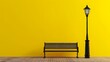 A bench with streetlight in front of a yellow wall.