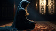 Muslim woman with prayer beads praying at home.
