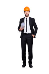 Sticker - Full length size portrait of attractive cheerful joyful investor in orange hard hat and black tux, tuxedo with tie, looking at camera, isolated on grey background, having paper roll in hand