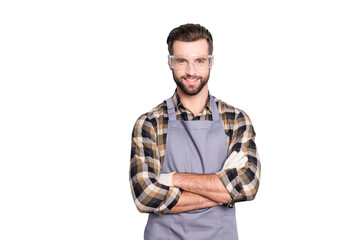 Wall Mural - Portrait of attractive joyful carpenter with hairstyle in safety glasses looking at camera having his arms crossed standing over grey background