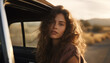 portrait of a cute woman leaning out of a car window. girl travels by car at sunset.