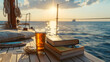 Aesthetic wide angle photograph of a pile of books and a beer pint glass on a yacht deck at sea. Sunshine. Product photography. Advertising. World book day.