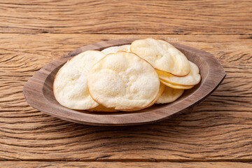 Wall Mural - Smoked provolone cheese chips in a bowl over wooden table