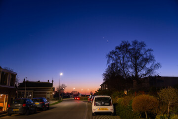 Jupiter and Saturn planets in the night sky appearing as a rare phenomenon at dusk during winter. The Great Conjunction an amazing and historical astronomical event at the end of day in Holland