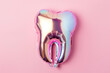 
foil balloon in tooth shape isolated on pastel pink background