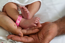 New Born Baby Feet On The Hands Of A Happy Dad 