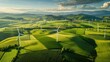 Wind turbines stand tall amidst the rolling hills of a lush agricultural landscape on a bright sunny day. 