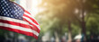 Waving American flag with bokeh background. US flag outdoor with blur background