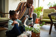 © Marko Geber - Father and daughter watering plants at home