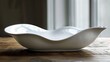 A white bowl sitting on top of a wooden table, AI