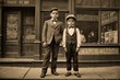 portrait of 10 year old children elegantly dressed in front of a barber shop in the streets of New York in the early twentieth century