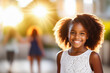 Young african american girl smiling happy standing at the city during sunset. Portrait of beautiful biracial girl smiling and looking at camera. Outdoor portrait of a smiling black girl