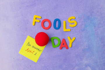 Wall Mural - April 1st. Image of letter Fools day and festive decor on the purple background