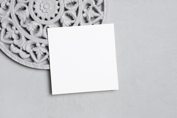 Blank square paper invitation card mockup with copy space, top view