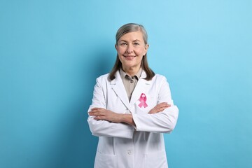 Poster - Mammologist with pink ribbon on light blue background. Breast cancer awareness