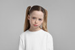 © New Africa - Portrait of sad girl on light grey background