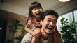 Cheerful playful daddy piggybacking little daughter kid with open flying hands. Adorable girl playing airplane on fathers back, enjoying activity, funny leisure, playtime on home sofa