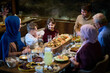 © .shock - A modern and traditional European Islamic family comes together for iftar in a contemporary restaurant during the Ramadan fasting period, embodying cultural harmony and familial unity amidst a